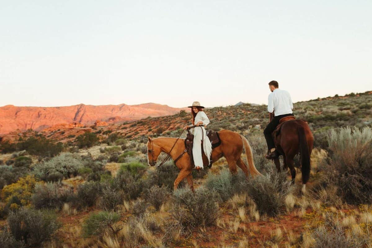 Bride and groom riding horseback to start their two day elopement adventure | Southern Utah Horseback Adventure Elopement | JoAnn's Photography | Zion Brides Feature