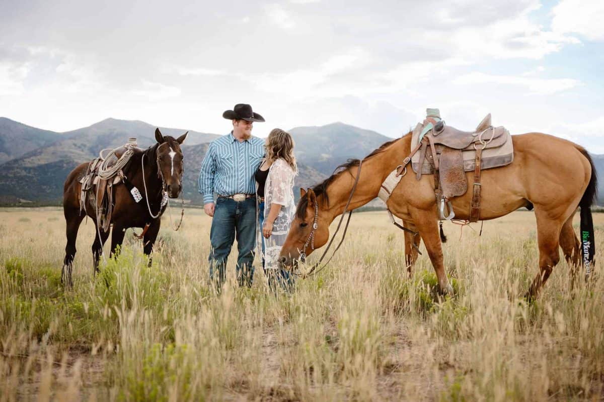 Couple in country western attire pose for portraits on their horses in Nevada with the mountains as a backdrop | Quiet and Intimate Ely Wedding with Horses | Mattie Rose Jensen | Zion Brides Feature