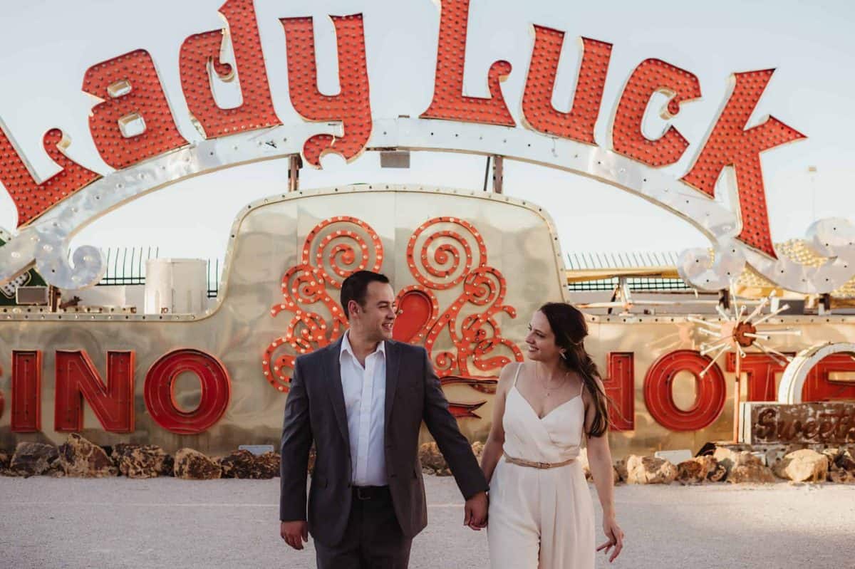 Couple at the Neon Museum having fun during their engagement session | Las Vegas Engagement Session at the Neon Museum | Amber Garrett Photography | Adventure Wed Feature