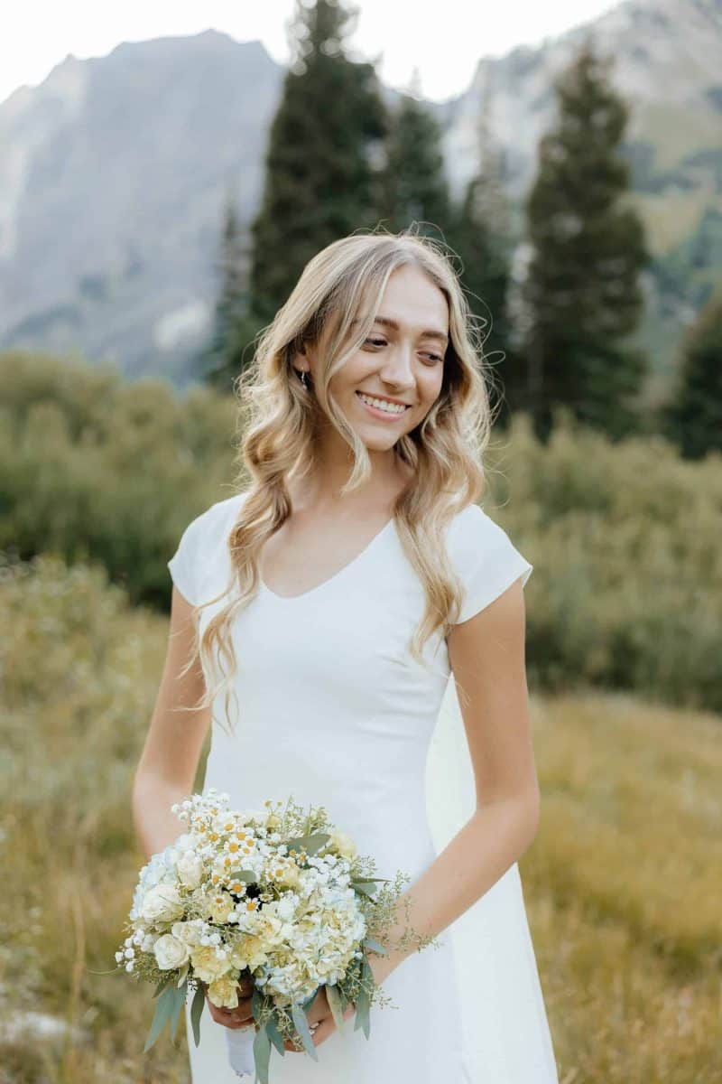 Alta Utah Summer Wedding Formal Session Groom in powder blue suit with blue floral tie, bride in classic white dress and veil with white floral wildflower bouquet | Alta Utah Summer Wedding Formal Session | Kae D Photography | Adventure Wed Feature
