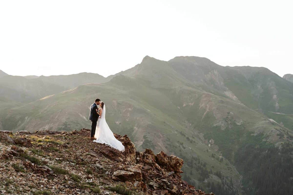 Bride and groom sharing moments at surnrise after off-roading above Ouray, Colorado | Ouray Gold Mountain Ranch Micro-Wedding | Larsen Photo Co. | Adventure Wed Feature