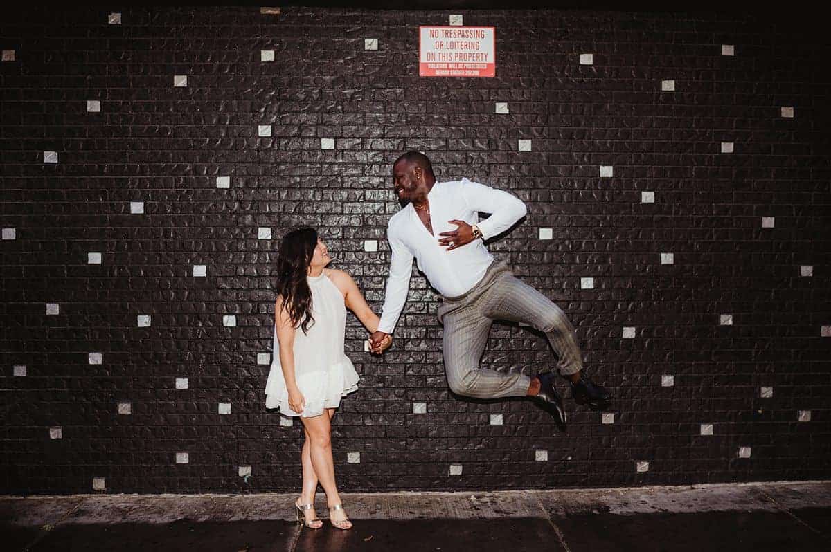 Couple celebrating elopement with a heel click in Las Vegas | Rainy Las Vegas Sure Thing Chapel Elopement | Amber Garrett Photography | Adventure Wed Feature